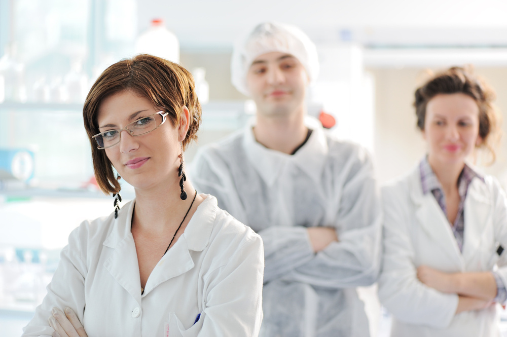 Three medical colleagues standing in laboratory